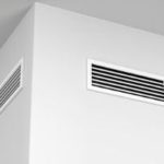 White air vent in a minimalist wall design, showcasing clean lines and a modern aesthetic for holiday HVAC decorations.