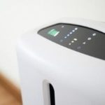 Air purifier with digital controls and LED lights for improved indoor air quality by Atlantic Heating & Air Conditioning.