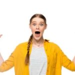 Young woman in a yellow shirt raises arms in surprise about boiler noises from Atlantic Heating & Air Conditioning services.