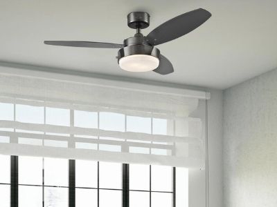 Ceiling fan with three blades and light fixture, mounted in a modern room, enhancing air circulation and cooling comfort in conjunction with air conditioning systems.