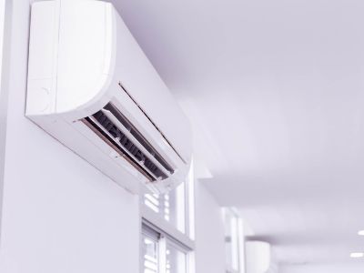 Ductless mini-split air conditioning unit mounted on a wall, showcasing modern HVAC technology for efficient cooling in homes.