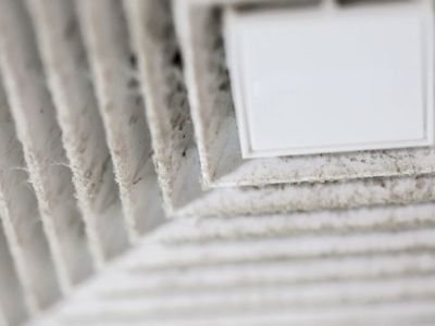 Dusty air vent with visible dirt and debris, indicating poor indoor air quality and potential damage to air ducts in a home.