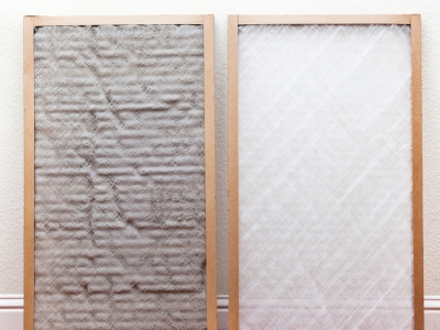 Dirty and clean air filters side by side, illustrating the impact of maintenance on HVAC efficiency and cooling performance.