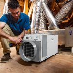 Technician installing dehumidifier